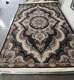 Large dark blue area rug with intricate floral and geometric patterns, suitable for living rooms or bedrooms.