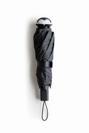 Black folding umbrella with a unique spiral pattern design and a purple circular tag.