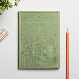 A hardcover notebook with a textured navy blue cover featuring the title "The New York Notebook". The notebook has blank pages inside and appears to be a high-quality stationery item.