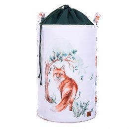 A large, round toy basket with a drawstring closure, featuring a whimsical illustration of a red fox sitting in a forest setting with flowers and leaves.