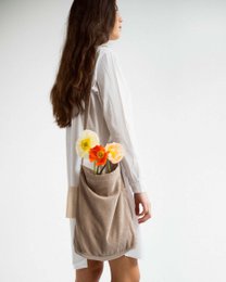Mocha-colored corduroy shoulder bag with floral applique detail.