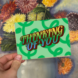 Colorful retro-style greeting card with the text "Thinking of You" on a green background.