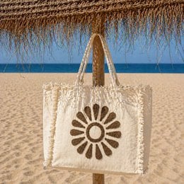 Cream canvas beach tote bag with flower daisy design, fringed edges, natural handles, available in brown camel mint green pink.
