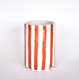 Cylindrical vase with vertical red and white stripes, cotto orange ceramic material, modern striped pattern design.