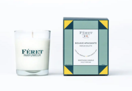 Violet-scented candle in a glass container with a geometric pattern box.