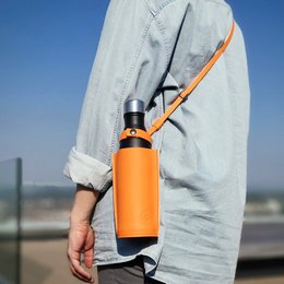 Bottle Bag - Grainy vegetarian leather bottle sleeve in gunpowder, tan, deep forest, papaya, or bourbon colors. Lightweight and durable design with adjustable strap.