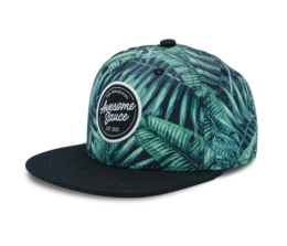 Tropical-themed snapback cap with lush green palm leaf pattern, adjustable fit, and branded patch.