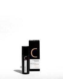 Concentrated vitamin C serum in a black bottle with a dropper applicator. Suitable for skin care and facial treatments.
