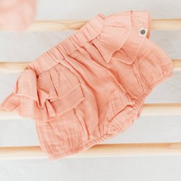 Peach muslin baby girl pants, 6-12 months and 3-6 months sizes available. Soft, ruffled, and comfortable for baby girls.
