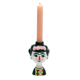 A round, tall pink candle holder in the shape of a Frida Kahlo-inspired figure, with a colorful, decorative design.