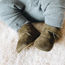 Moss green suede baby shoes with a classic design and soft, comfortable fit. Available in sizes 18-21.