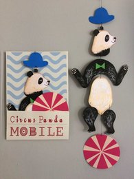 Colorful panda-themed mobile with kinetic elements, featuring a panda figure, clouds, and geometric shapes. Suitable for nursery or children's room decor.