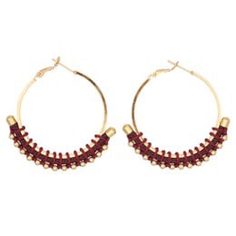 Colorful golden hoop earrings with beaded accents in blue, fuchsia, green, black, and navy blue.