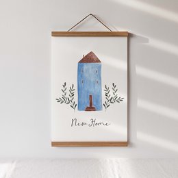 This art print features a whimsical illustration of a blue house with the text "New Home" below it. The print is available in three sizes: A5, A4, and A3. The illustration showcases a simple, minimalist style with floral elements surrounding the house.