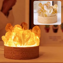  Citrine gemstone lamp with natural, irregular-shaped yellow crystals in a wooden base, providing warm, ambient lighting for abundance, clarity, and conscious alignment.