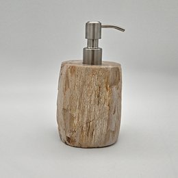  Petrified wood soap dispenser with a natural, rustic appearance and a stainless steel pump.