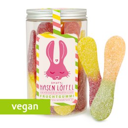 Candy cane-shaped rabbit gummy candies in a glass jar. The candies have a vibrant pink and yellow color scheme, and the jar features a cute rabbit illustration.