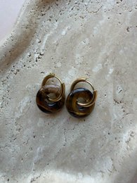 Gold twisted knot stud earrings, small round metallic jewelry, classic elegant design.