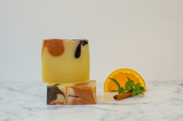 Orange and cedar scented soap bar with natural ingredients.