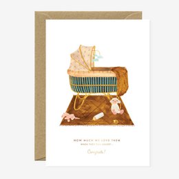 Cozy baby bassinet with soft blanket and toys, perfect for a newborn.