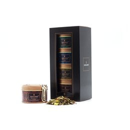 A set of 6 assorted tea tins in a black storage container. The tins feature various tea blends and designs, suggesting a diverse tea gift set.