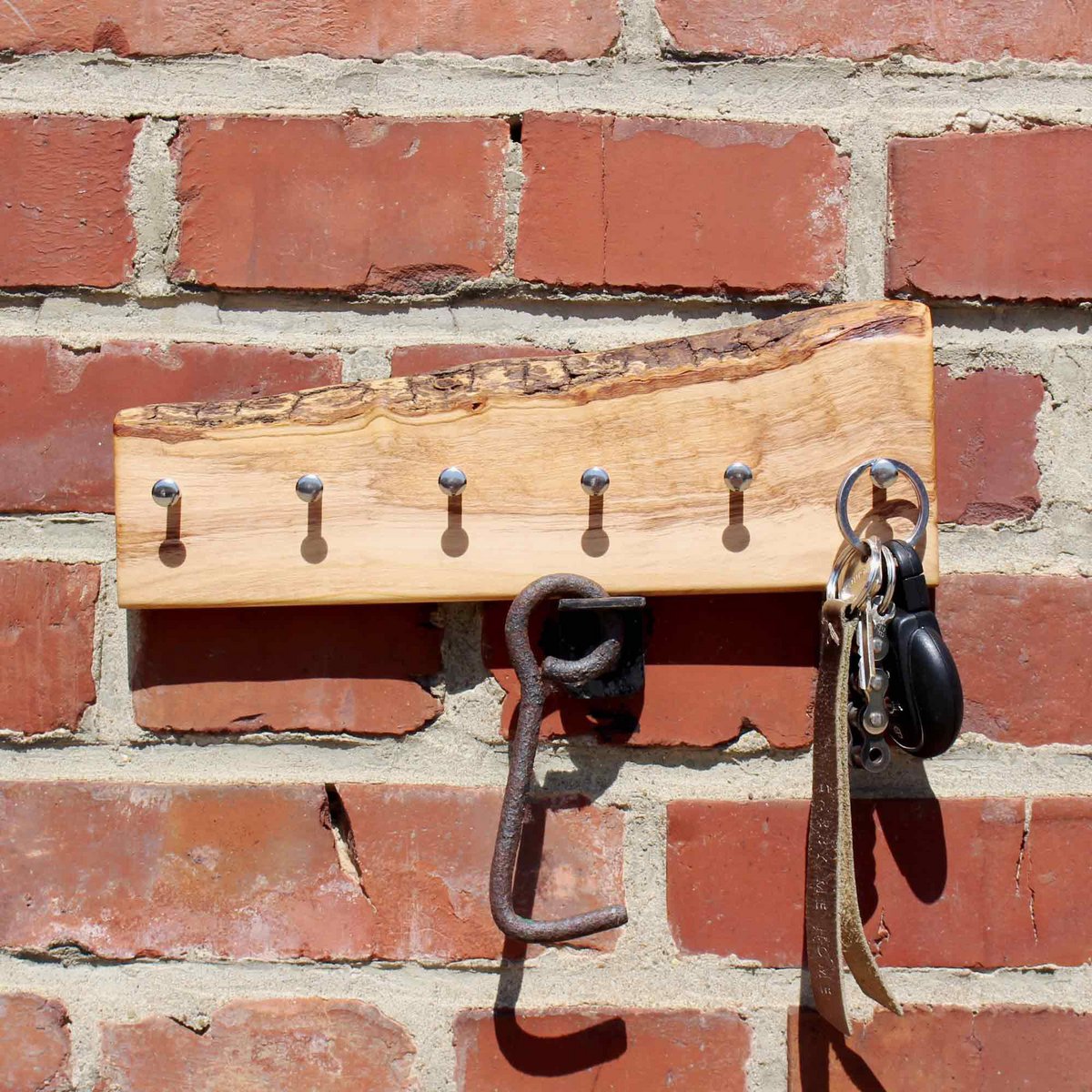 Key holder made of olive wood with bark