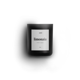 Scented candle with a lemon fragrance, presented in a black glass container.