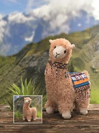 Cuddly beige plush llama toy, 23cm in size, ready to be stuffed and customized. Features a soft, furry texture and a colorful patterned scarf.