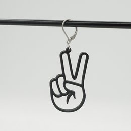 Peace statement earrings in lilac, black, and gold colors featuring a peace sign symbol.