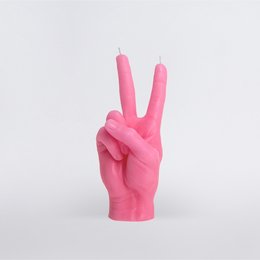 Pink, tall, cylindrical candle in a white box with a peace sign design.