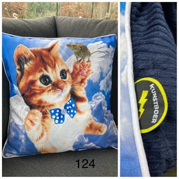 Cushion cover featuring a cute orange kitten with a blue bow tie against a blue sky background. The cushion cover is made of soft, plush material and would make a cozy addition to any home decor.
