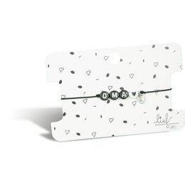 A black and white bracelet with a charm, suitable for a grandmother. The bracelet has a simple, elegant design with a small charm attached.