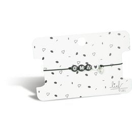 A black and white bracelet with a charm, suitable for a grandmother. The bracelet has a simple, elegant design with a small charm attached.