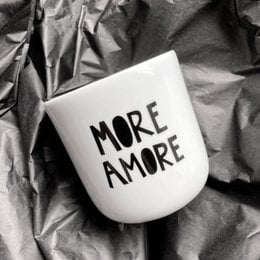 White ceramic mug with the text "MORE AMORE" printed in black.