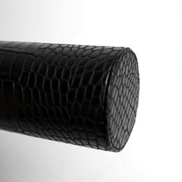 Round soap dispenser in crocodile look-black and stainless steel