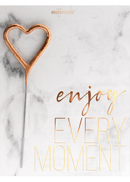 A decorative heart-shaped wire frame with the text "enjoy every moment" written in a cursive font on a marble background.