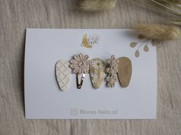 A set of 20 assorted hair clips for kids, featuring a variety of shapes and designs including floral, butterfly, and leaf motifs.