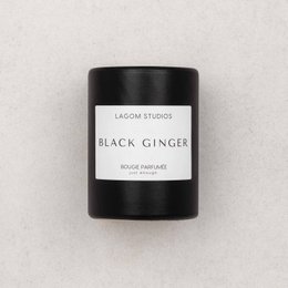 Tall, round black scented candle with the aroma of ginger.