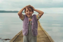Lilac-colored woolen body warmer for kids, available in sizes 74/80 to 146/152.