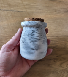 Small white ceramic spice jar with cork lid, suitable for storing spices or other dry goods.