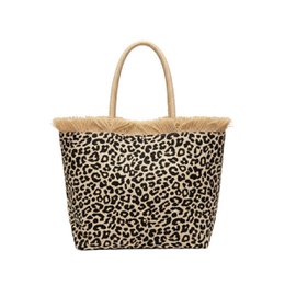  Leopard print tote bag with beige handles and trim. Made of durable material, suitable for everyday use or travel. Measures approximately 15 inches wide and 12 inches tall.