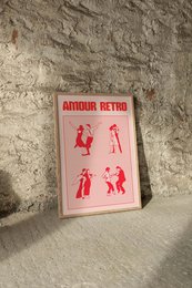 Retro-style wall art featuring silhouettes of people in various poses. The artwork has a vintage, minimalist aesthetic with a bold red and white color scheme.