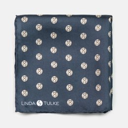 A navy blue handkerchief with white polka dots, suitable for use as a pocket square.