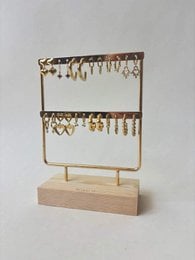 # Product Description
Gold metal jewelry display stand with two tiers, wooden base, hanging chains and hooks for necklaces and bracelets.
