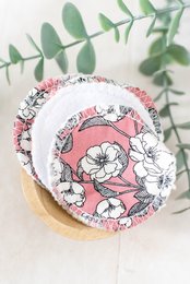 Soft, reusable face wipes made of fleece or terry towelling material, featuring floral patterns in pink, white, and blue colors.