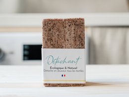 Stain remover soap bar, brown color, rectangular shape, packaged in cardboard box.