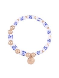 A bracelet with a beaded design featuring a mix of blue and gold-colored beads, creating a stylish and elegant accessory.