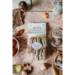 Tagliatelle pasta with chestnuts, golden brown ribbon noodles, artisanal Italian style packaging