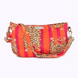 Vibrant shoulder bag with tiger print and pom-pom accents, made of colorful striped fabric.