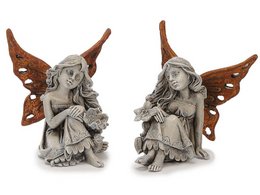 A pair of small, decorative fairy statues with brown wings and detailed sculpting. The fairies appear to be sitting and have a whimsical, fantasy-inspired design.